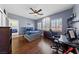 This bedroom has hardwood floors, a ceiling fan, and cozy, neutral-colored walls at 2113 Waterbury Ln, Las Vegas, NV 89134