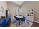 Formal dining area featuring hardwood floors, tray ceiling, chandelier, and bar with seating at 2113 Waterbury Ln, Las Vegas, NV 89134