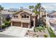 Charming two-story home with a three-car garage, well-manicured lawn, and beautiful desert landscaping at 2113 Waterbury Ln, Las Vegas, NV 89134