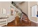 Open foyer with curved staircase, hardwood floors, decorative niche, and a welcoming ambiance at 2113 Waterbury Ln, Las Vegas, NV 89134