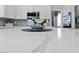 Close-up on kitchen island marble countertop with stylish decor and view of stainless steel appliances at 2113 Waterbury Ln, Las Vegas, NV 89134
