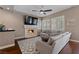 Comfortable living room with fireplace, ceiling fan, plantation shutters, and hardwood flooring at 2113 Waterbury Ln, Las Vegas, NV 89134