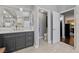 Bright bathroom featuring double sinks with marble countertops and a view to other rooms at 2113 Waterbury Ln, Las Vegas, NV 89134