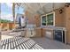 This outdoor kitchen features a built-in grill, counter space, and a mini-refrigerator at 2113 Waterbury Ln, Las Vegas, NV 89134