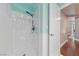 A modern shower with glass enclosure, white walls and tile trim at 2113 Waterbury Ln, Las Vegas, NV 89134
