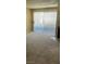 Bright living room with neutral carpet, a fireplace, and sliding door, creating an inviting space for relaxation and entertainment at 2200 S Fort Apache Rd # 2062, Las Vegas, NV 89117
