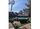 Community pool with manicured landscaping, fence, and umbrellas, set among mature shade trees at 2200 S Fort Apache Rd # 2062, Las Vegas, NV 89117