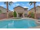 Backyard pool and spa area with lush landscaping and a patio at 2445 Rue Royale, Henderson, NV 89044