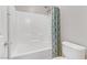 Bright bathroom featuring a shower over tub with a patterned curtain at 2445 Rue Royale, Henderson, NV 89044