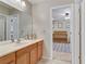 Bright bathroom featuring a vanity with wood cabinets and a bedroom view at 2445 Rue Royale, Henderson, NV 89044