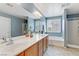 Spacious bathroom featuring a large vanity with double sinks, soaking tub, and glass-enclosed shower at 2445 Rue Royale, Henderson, NV 89044