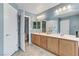 Bathroom featuring a double sink vanity with storage, tile floors, and white doors at 2445 Rue Royale, Henderson, NV 89044