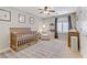 Charming Bedroom features a crib, comfortable chair, and window with plantation shutters at 2445 Rue Royale, Henderson, NV 89044