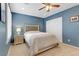 Comfortable bedroom with a ceiling fan, shutters, and neutral carpet at 2445 Rue Royale, Henderson, NV 89044