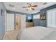 Comfortable bedroom with a ceiling fan, shutters, and neutral carpet at 2445 Rue Royale, Henderson, NV 89044