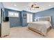 Comfortable bedroom with a ceiling fan, shutters, and neutral carpet at 2445 Rue Royale, Henderson, NV 89044