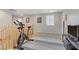 Spacious upstairs bonus room featuring exercise equipment, shutters, and neutral decor at 2445 Rue Royale, Henderson, NV 89044