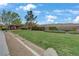 Open green space in the community surrounded by walking paths and desert landscaping at 2445 Rue Royale, Henderson, NV 89044