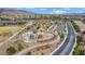 The aerial shot shows a well-maintained community park with walking paths and playground at 2445 Rue Royale, Henderson, NV 89044