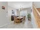 Dining room features a rustic wood table, stairway and neutral wall color scheme at 2445 Rue Royale, Henderson, NV 89044