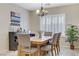 Dining room features a rustic wood table, plantation shutters and neutral wall color scheme at 2445 Rue Royale, Henderson, NV 89044