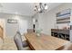 Dining room featuring a rustic wood table, bar area and neutral wall color scheme at 2445 Rue Royale, Henderson, NV 89044