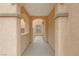 Inviting entryway with neutral paint, textured arches, and view of the well-lit interior at 2445 Rue Royale, Henderson, NV 89044