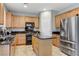 Updated kitchen with stainless steel appliances, a center island, and ample cabinet space for storage at 2445 Rue Royale, Henderson, NV 89044