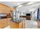 Open kitchen with stainless steel refrigerator and center island, seamlessly connected to the living area at 2445 Rue Royale, Henderson, NV 89044