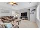 The living room offers a plush leather sofa, a large television, and bright windows with plantation shutters at 2445 Rue Royale, Henderson, NV 89044