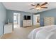 Bright main bedroom featuring blue walls, shutters, carpet, and access to main bathroom at 2445 Rue Royale, Henderson, NV 89044