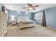 Main bedroom boasts blue walls, shutters, ceiling fan, and carpet flooring at 2445 Rue Royale, Henderson, NV 89044