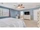 Large main bedroom featuring blue walls, shutters, carpet, and light colored furnishings at 2445 Rue Royale, Henderson, NV 89044