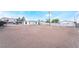 View of the flat backyard with metal fences under a blue sky and distant home at 266 Tungsten St, Henderson, NV 89015