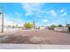 View of the flat backyard with metal fences under a blue sky at 266 Tungsten St, Henderson, NV 89015