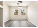 Bright bedroom featuring gray wood floors, neutral walls, a ceiling fan, and two windows at 266 Tungsten St, Henderson, NV 89015