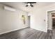 This modern bedroom has gray wood floors, neutral walls, a ceiling fan, and a closet at 266 Tungsten St, Henderson, NV 89015