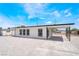 Angled view of home with white rock landscaping, carport, black trim, and fresh exterior paint at 266 Tungsten St, Henderson, NV 89015