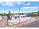 White single story home with gravel landscaping, a carport, and a fenced yard at 266 Tungsten St, Henderson, NV 89015