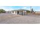 Angled view of home with white rock landscaping, carport, black trim, and fresh exterior paint at 266 Tungsten St, Henderson, NV 89015