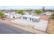 White single story home with gravel landscaping, a carport, and a fenced yard at 266 Tungsten St, Henderson, NV 89015