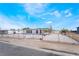 Charming single-story home with a white exterior, black trim, a gated yard, and clear blue skies at 266 Tungsten St, Henderson, NV 89015