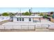 White single story home with gravel landscaping, a carport, and a fenced yard at 266 Tungsten St, Henderson, NV 89015