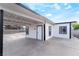 Angled view of home exterior featuring a carport with a concrete base and black support beams at 266 Tungsten St, Henderson, NV 89015