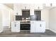Modern kitchen with white cabinets, stainless steel appliances, dark backsplash, and countertops at 266 Tungsten St, Henderson, NV 89015