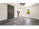 Bright, open living room features gray wood floors, a modern fireplace and view into the kitchen at 266 Tungsten St, Henderson, NV 89015