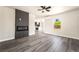 Bright, open living room features gray wood floors, a modern fireplace and view into the kitchen at 266 Tungsten St, Henderson, NV 89015
