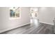 Bright living room featuring gray hardwood flooring, white walls, and large windows at 266 Tungsten St, Henderson, NV 89015