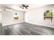 Bright living room featuring gray hardwood flooring, neutral walls, ceiling fan, and an AC unit at 266 Tungsten St, Henderson, NV 89015