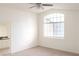 Bright bedroom featuring a large arched window, neutral carpet and adjacent bathroom at 2753 Devita Cir, Las Vegas, NV 89117